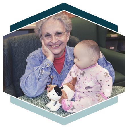 Alzheimer's resident poses with baby doll