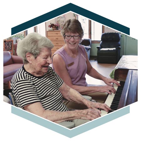 Alzheimer's resident and instructor play piano